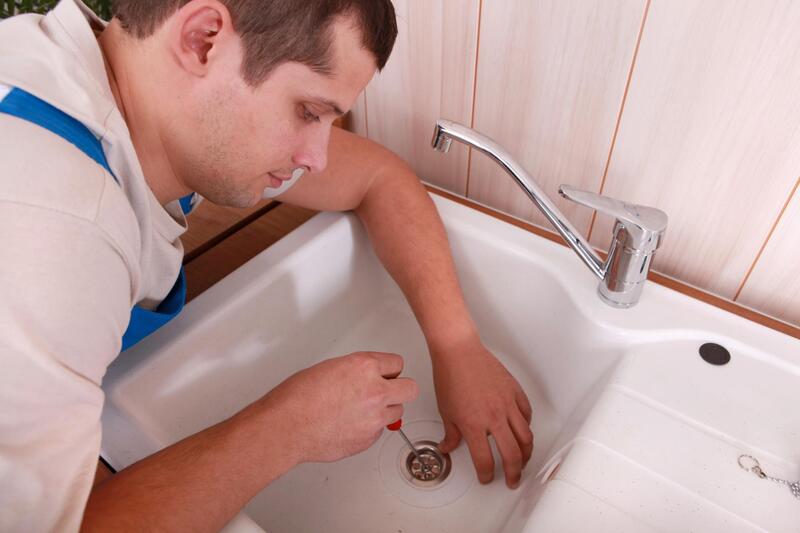 man fixing sink services